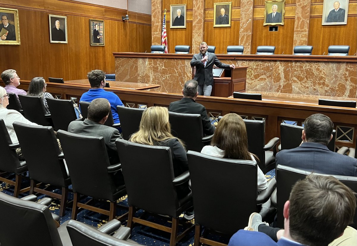 Justice Sullivan speaking at the podium in the Texas Supreme Court chamber